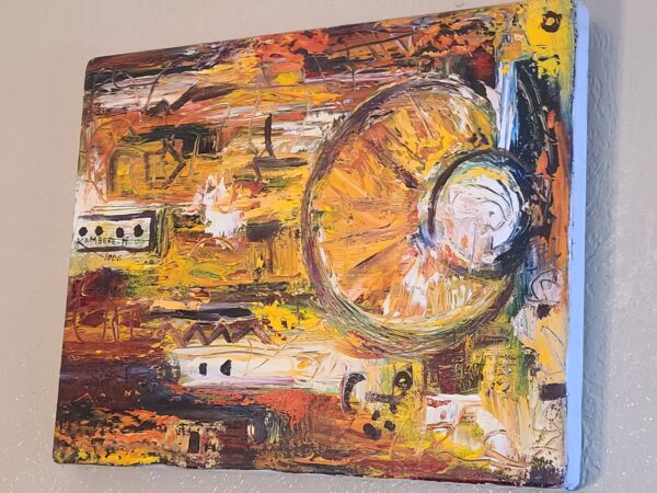 A painting of an orange and yellow abstract design.